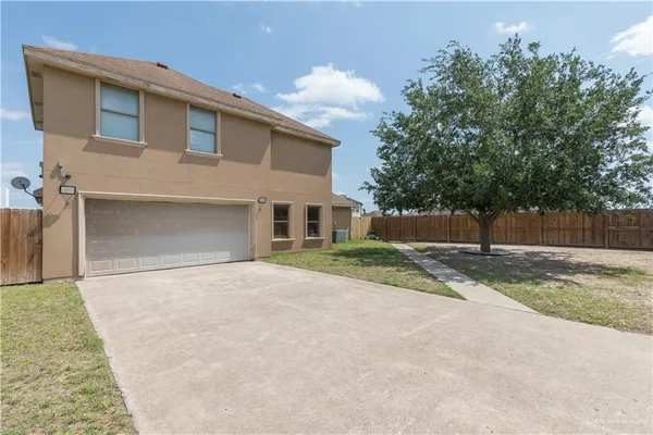 front view of a house with a yard and a garage