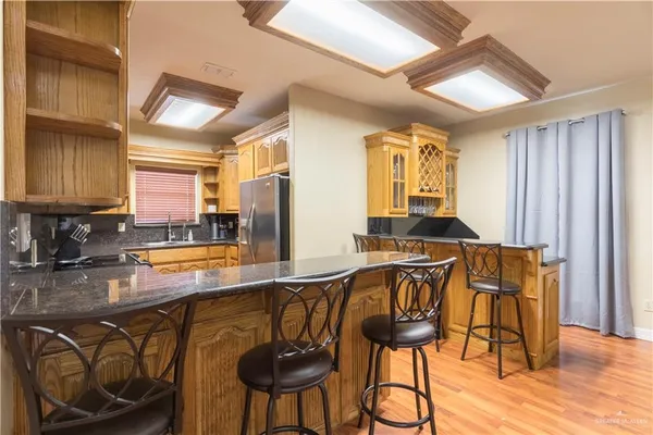 a view of a kitchen area with furniture and wooden floor