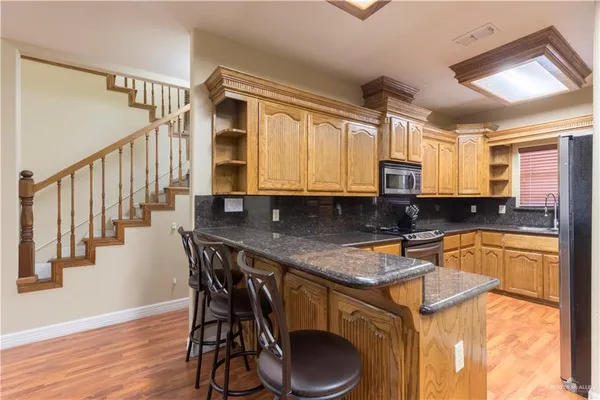 a kitchen with a table chairs sink and cabinets