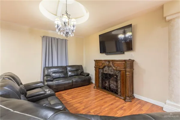 a living room with furniture a flat screen tv and a fireplace