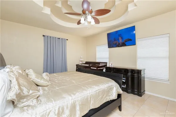 a bedroom with a bed and a chandelier