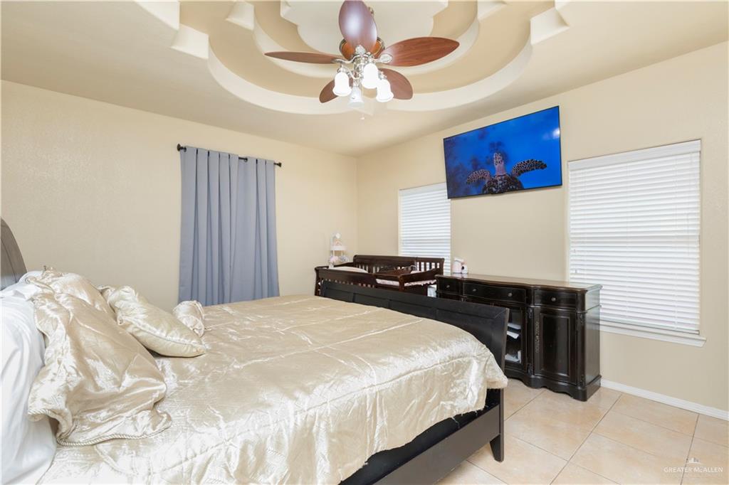 616 Gable Drive Pharr, TX 78577 - Photo 9 of 22 a bedroom with a bed and a chandelier