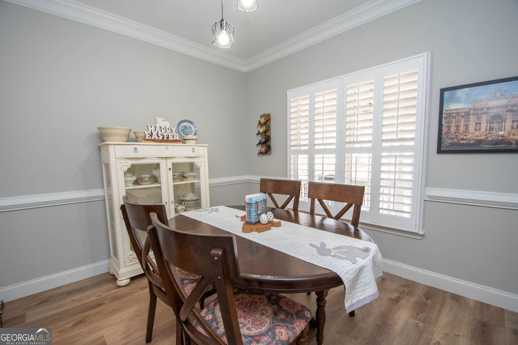 100 Spring Forest Trail Sharpsburg, GA 30277 - Photo 13 of 39 a view of a dining room with furniture window and wooden floor