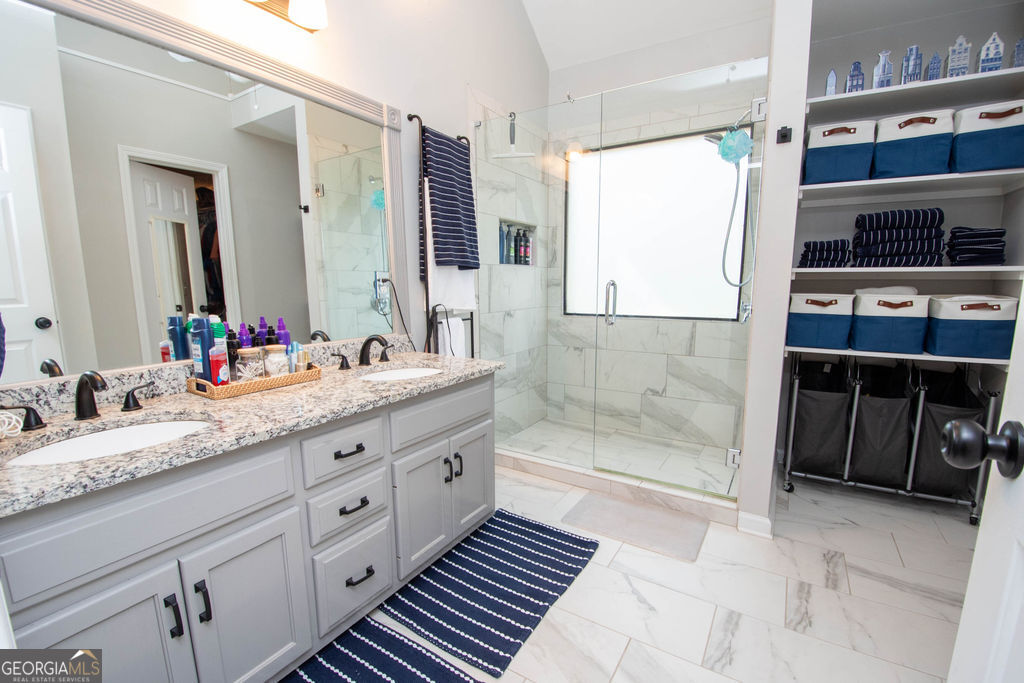 100 Spring Forest Trail Sharpsburg, GA 30277 - Photo 17 of 39 a bathroom with a granite countertop sink a mirror and a shower