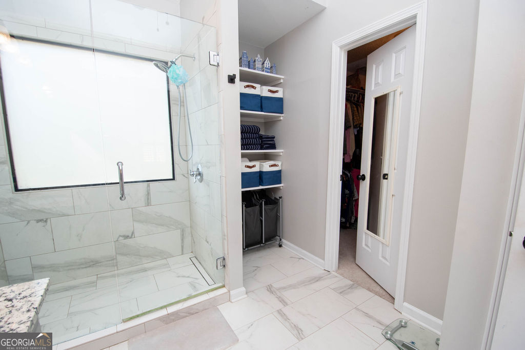 100 Spring Forest Trail Sharpsburg, GA 30277 - Photo 18 of 39 a bathroom with a bathtub and a shower