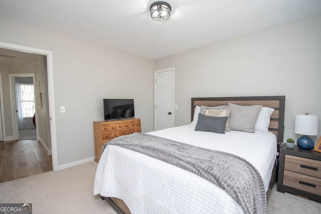 100 Spring Forest Trail Sharpsburg, GA 30277 - Photo 20 of 39 a bedroom with bed and window