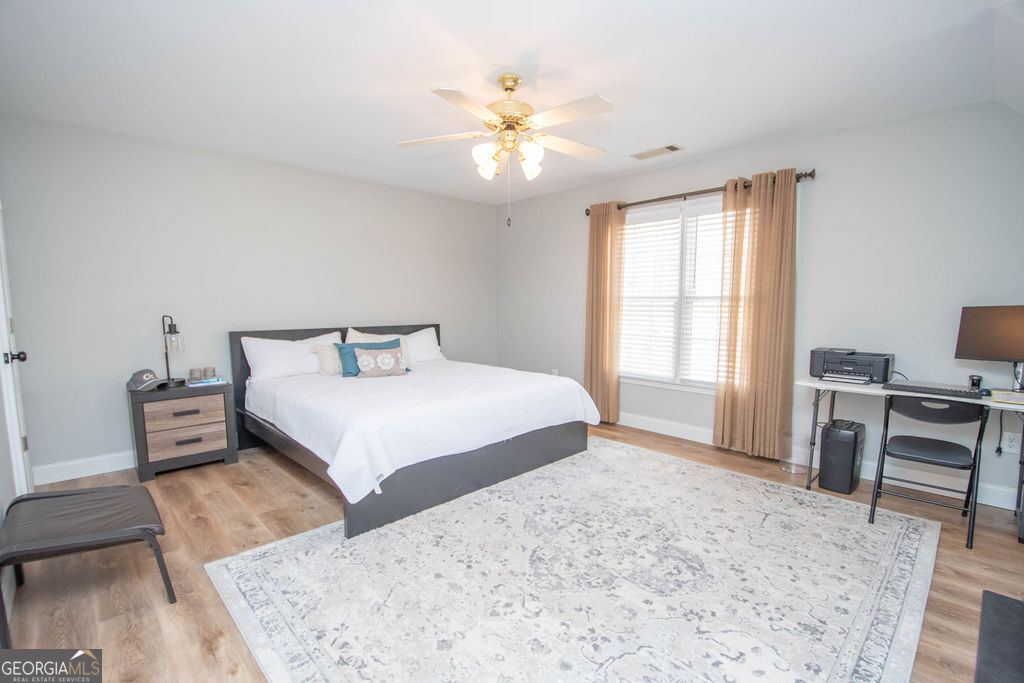100 Spring Forest Trail Sharpsburg, GA 30277 - Photo 21 of 39 a bedroom with a bed and a desk