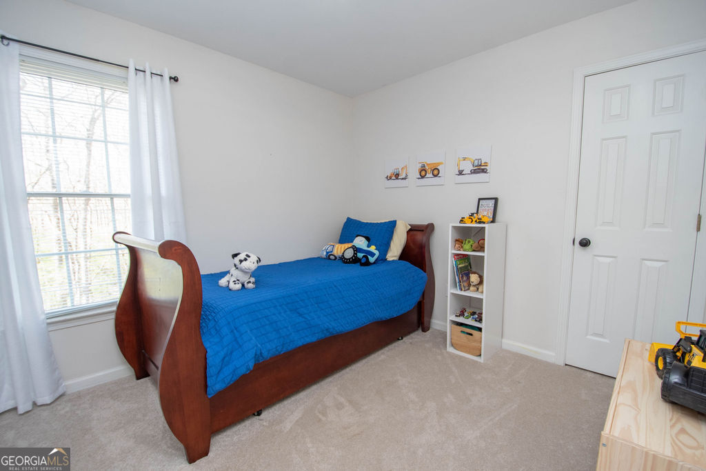 100 Spring Forest Trail Sharpsburg, GA 30277 - Photo 23 of 39 a bedroom with a bed and a window