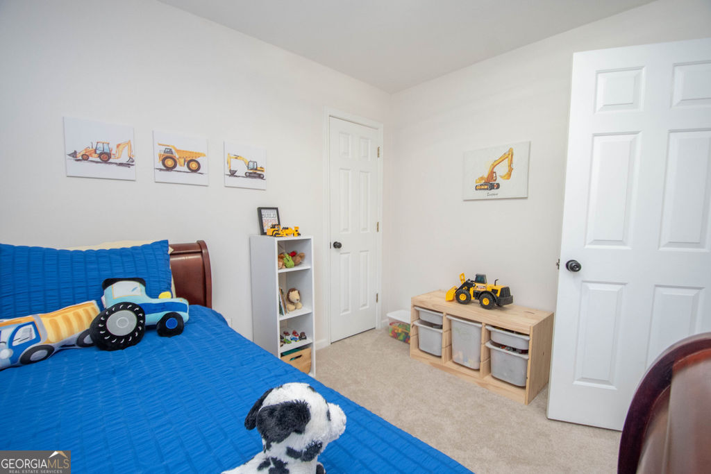 100 Spring Forest Trail Sharpsburg, GA 30277 - Photo 24 of 39 a room with toys and wooden floor