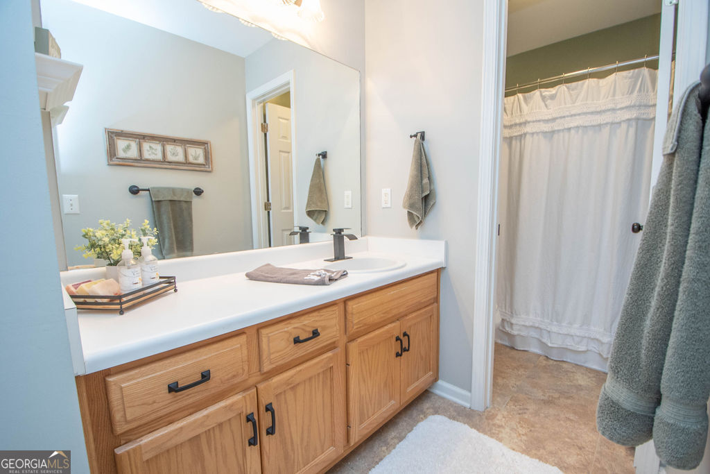 100 Spring Forest Trail Sharpsburg, GA 30277 - Photo 25 of 39 a bathroom with a double vanity sink and a mirror
