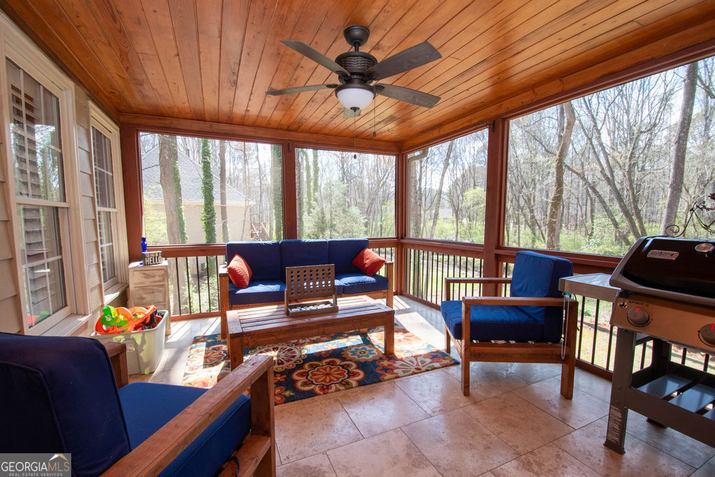 100 Spring Forest Trail Sharpsburg, GA 30277 - Photo 27 of 39 a living room with furniture a ceiling fan and a large window