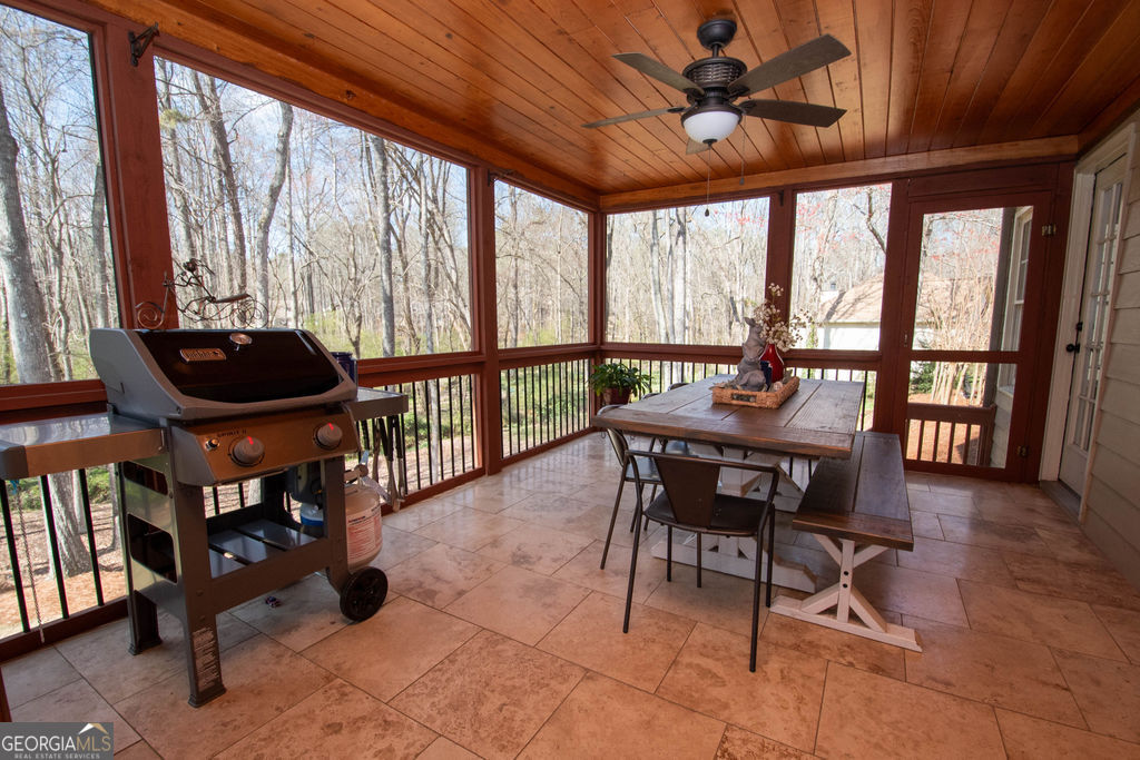 100 Spring Forest Trail Sharpsburg, GA 30277 - Photo 29 of 39 a dining room with furniture and a floor to ceiling window