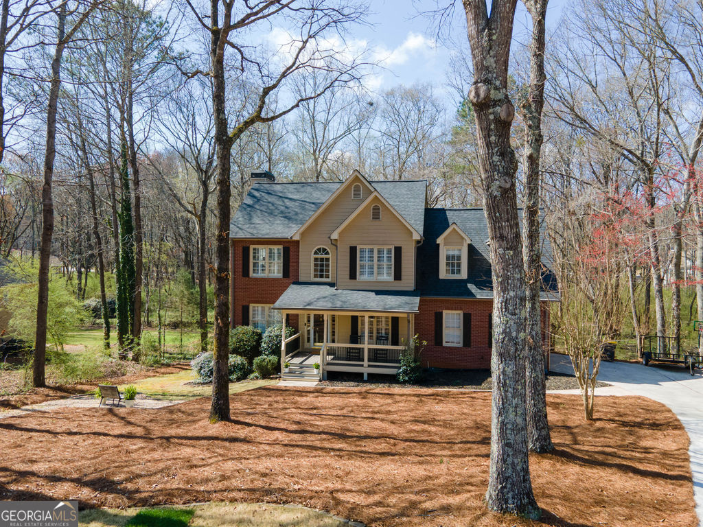 100 Spring Forest Trail Sharpsburg, GA 30277 - Photo 3 of 39 a front view of a house with a yard
