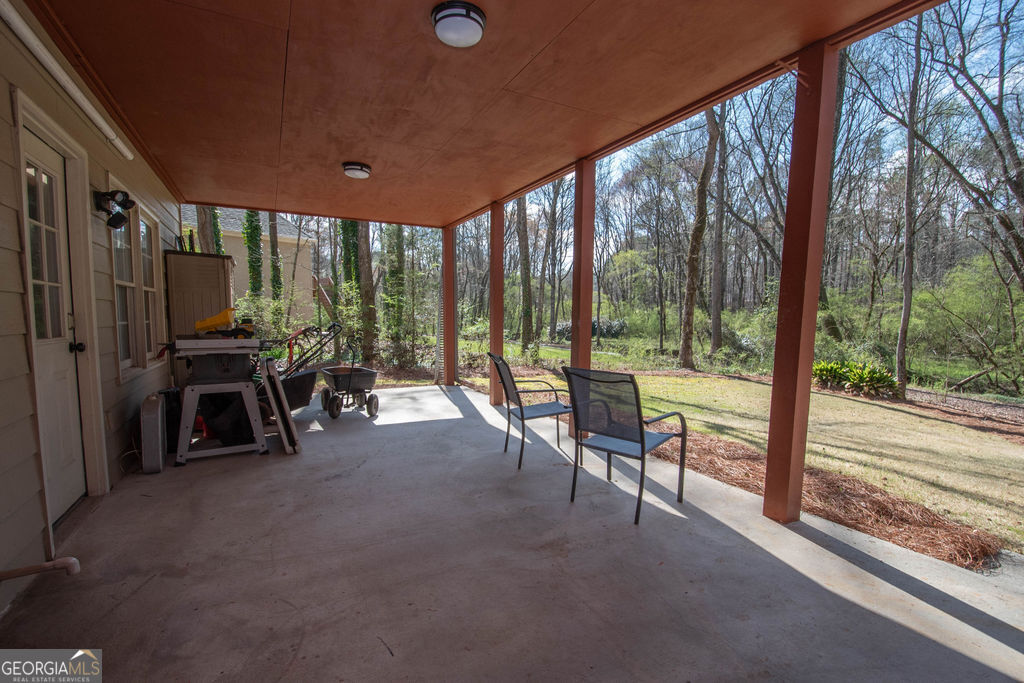 100 Spring Forest Trail Sharpsburg, GA 30277 - Photo 31 of 39 a view of a porch with chairs and backyard