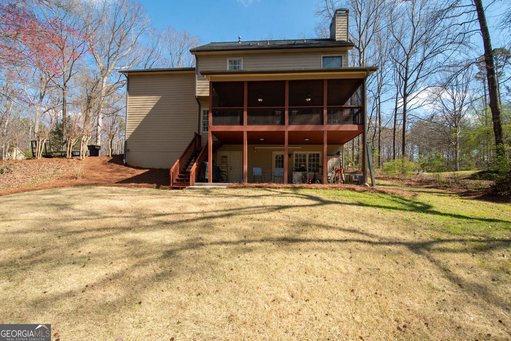 100 Spring Forest Trail Sharpsburg, GA 30277 - Photo 34 of 39 a view of a house with a backyard and a tree