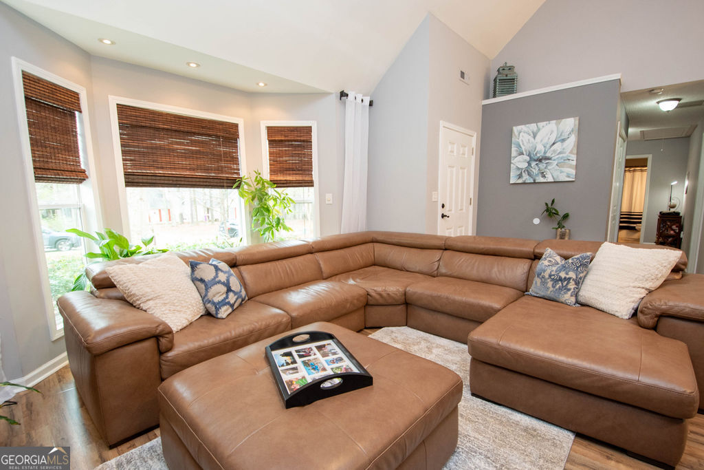 100 Spring Forest Trail Sharpsburg, GA 30277 - Photo 5 of 39 a living room with furniture a large window and a table