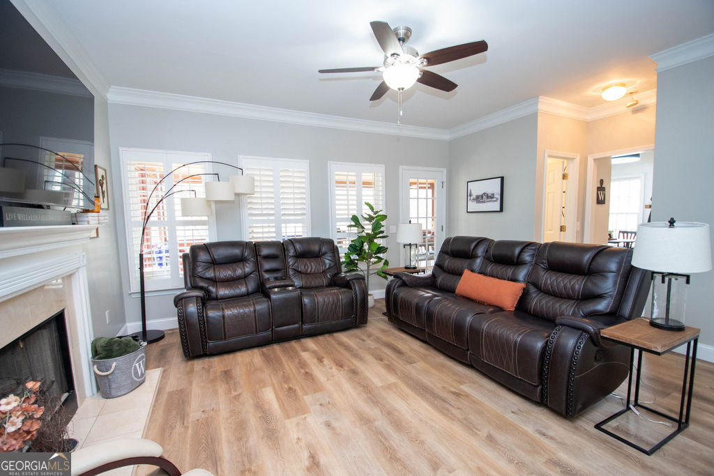 100 Spring Forest Trail Sharpsburg, GA 30277 - Photo 6 of 39 a living room with furniture a fireplace and a flat screen tv