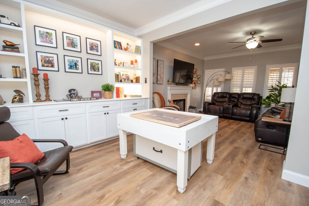 100 Spring Forest Trail Sharpsburg, GA 30277 - Photo 7 of 39 a living room with stainless steel appliances kitchen island granite countertop a sink a stove a dining table and chairs with wooden floor
