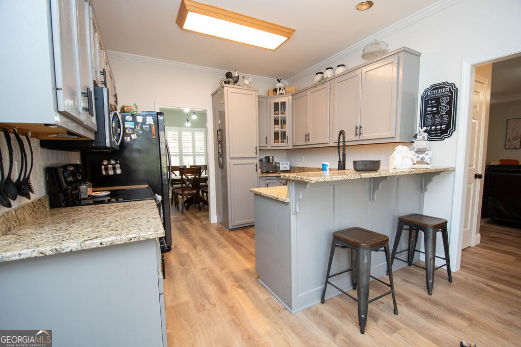 100 Spring Forest Trail Sharpsburg, GA 30277 - Photo 10 of 39 a kitchen with stainless steel appliances granite countertop sink stove top oven and cabinets