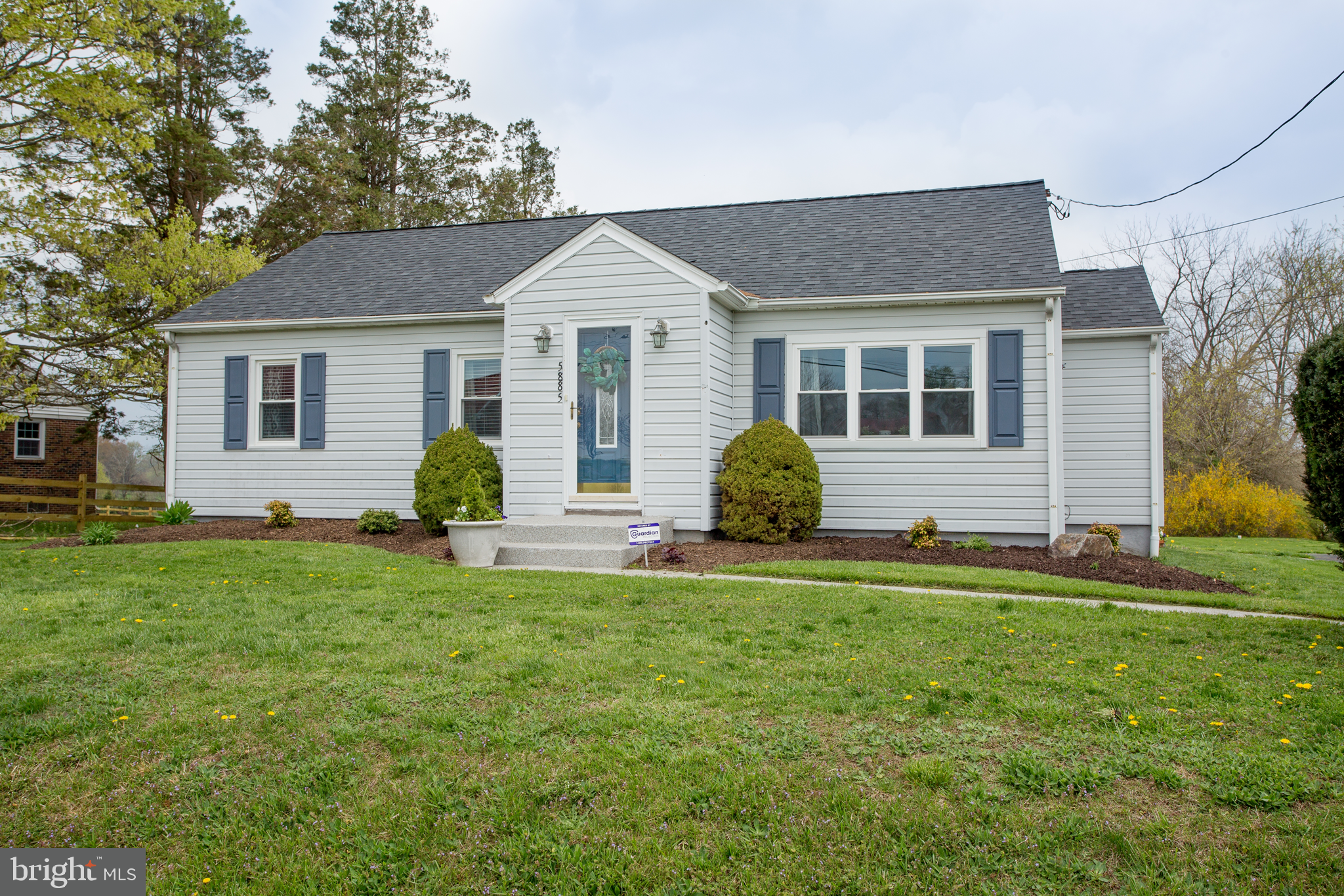 a front view of a house with a garden
