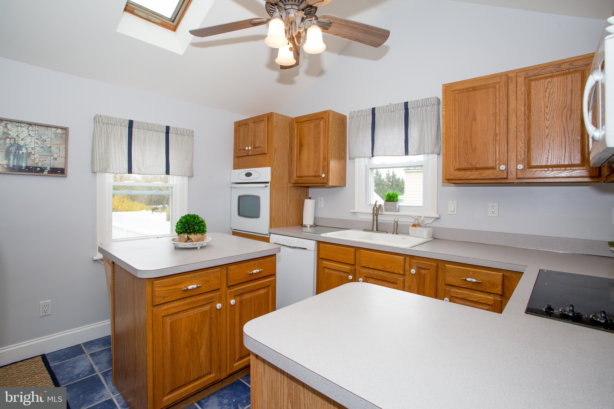 5885 Telegraph Road Elkton, MD 21921 - Photo 14 of 27 a kitchen with a sink a stove cabinets and wooden floor