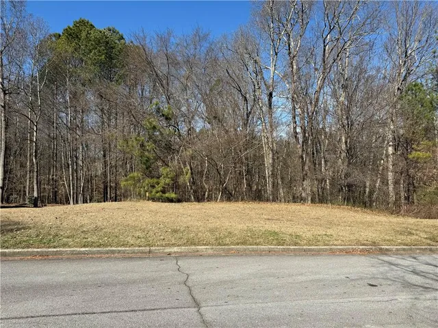 a white house with a snow on the road