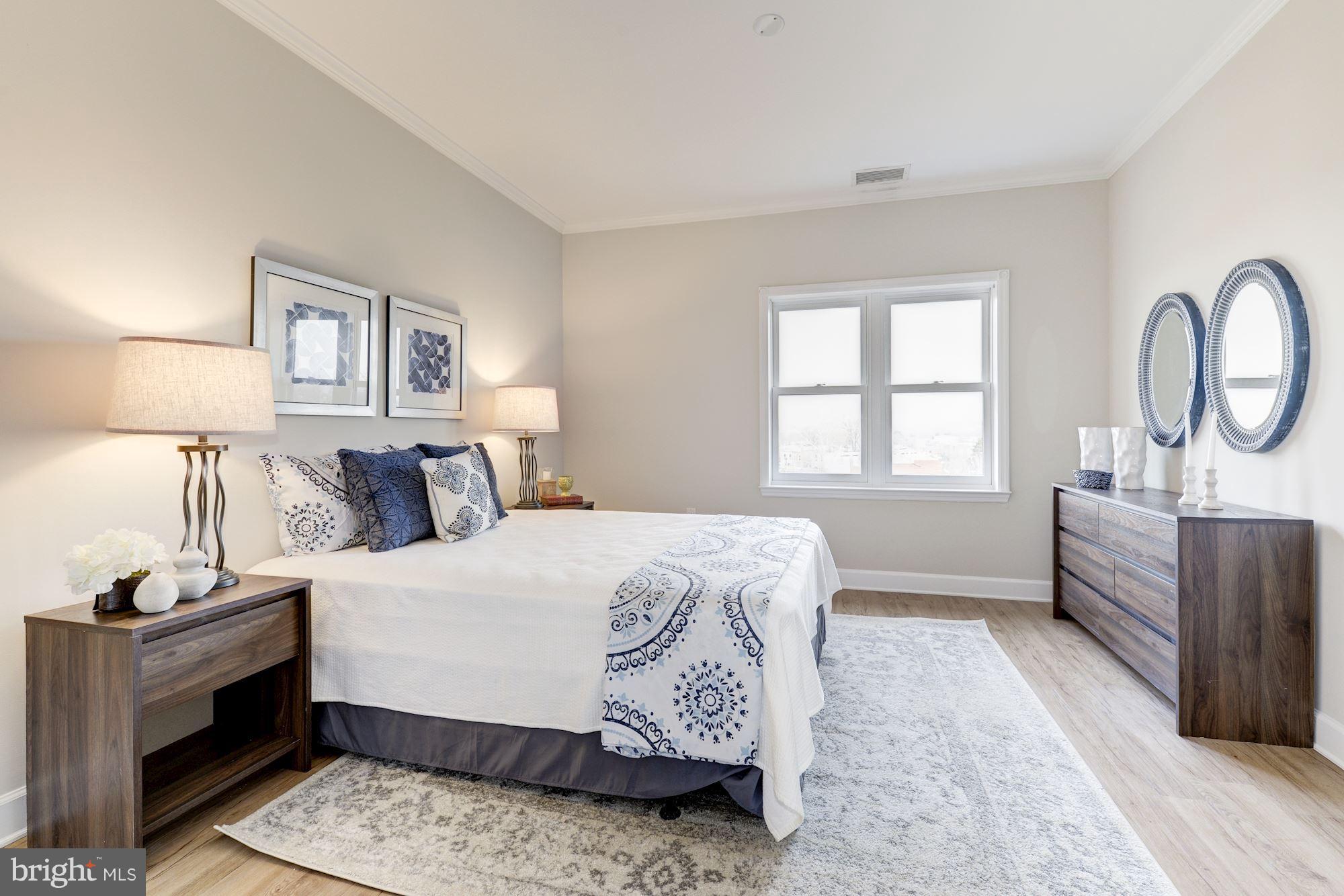 401 13th Street Northeast, Unit PH8 Washington, DC 20002 - Photo 17 of 27 a bedroom with a bed and a window