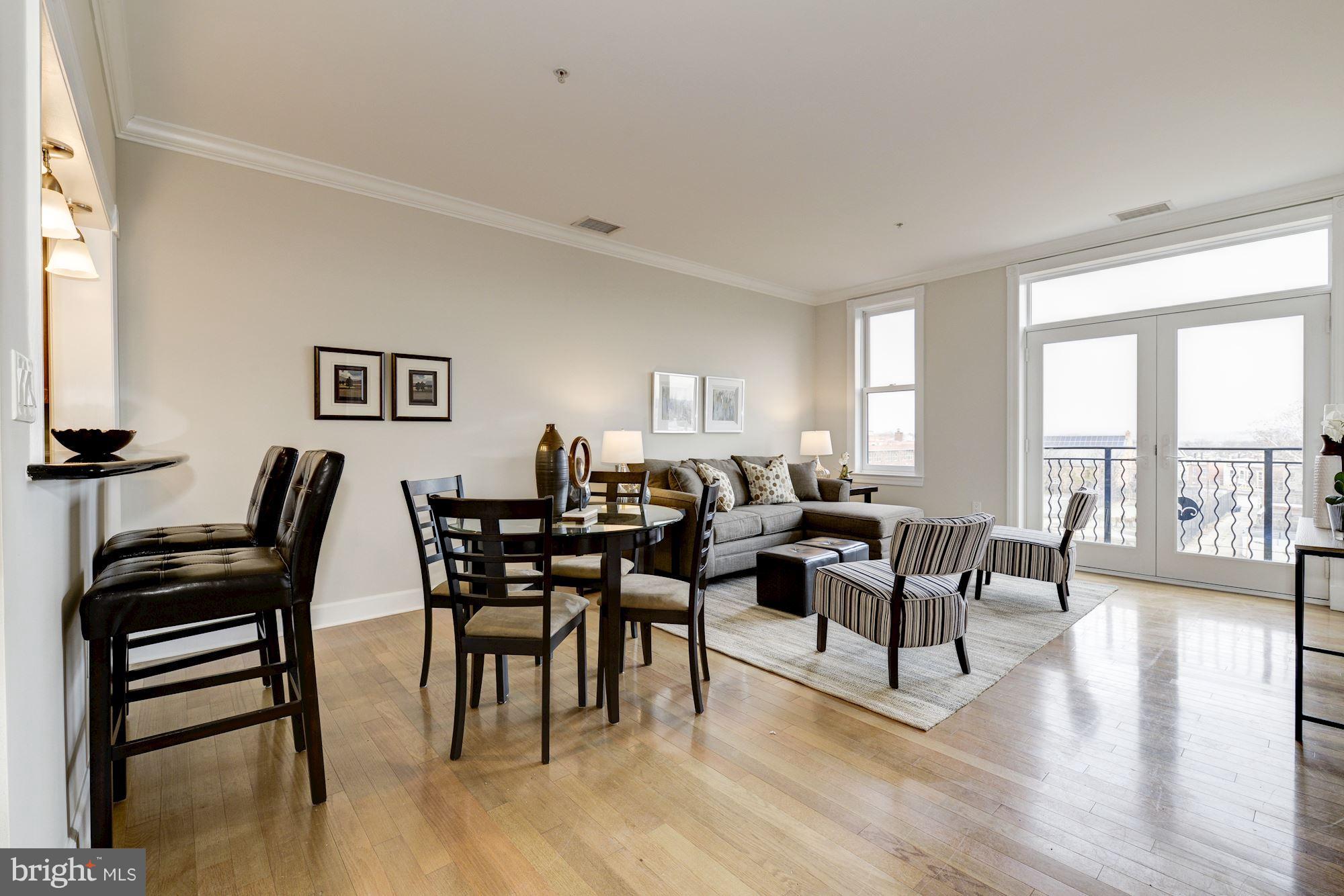 401 13th Street Northeast, Unit PH8 Washington, DC 20002 - Photo 10 of 27 a living room with furniture wooden floor and a floor to ceiling window