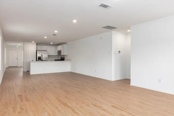 a view of a kitchen with a sink and a refrigerator