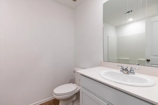 a bathroom with a sink toilet and a mirror