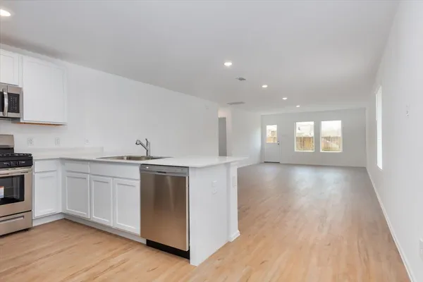a kitchen with a sink and stove top oven