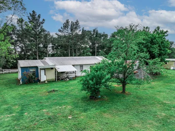a aerial view of a house with a yard and deck