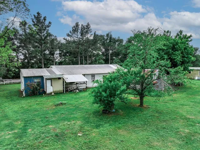 a aerial view of a house with a yard and deck