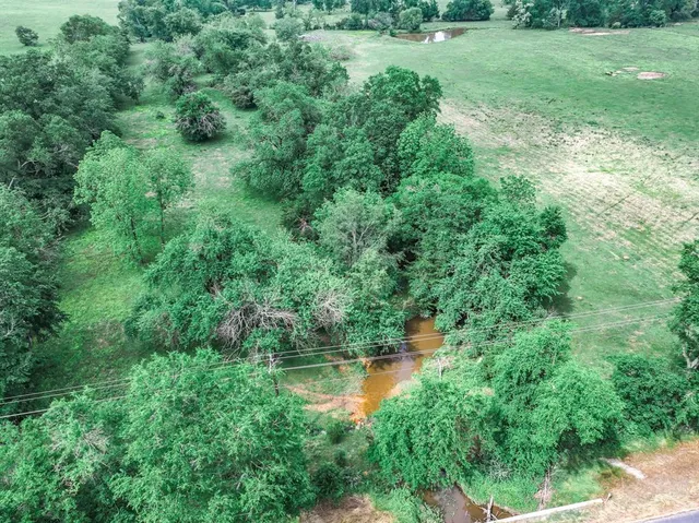 a view of a wooden deck with a table and chairs under an umbrella