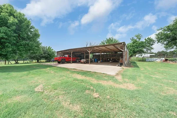 a kitchen with stainless steel appliances a refrigerator a stove a dining table and chairs