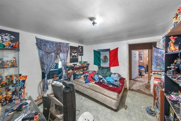 a bedroom with furniture and a mirror