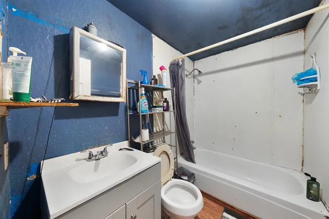 a bed room with a bed and a chair