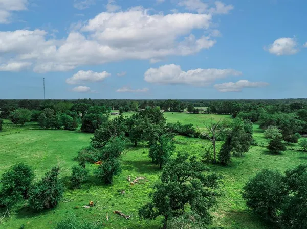 an aerial view of a house with yard and outdoor seating