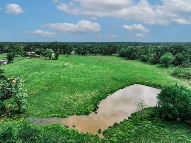 a view of a swimming pool and a yard