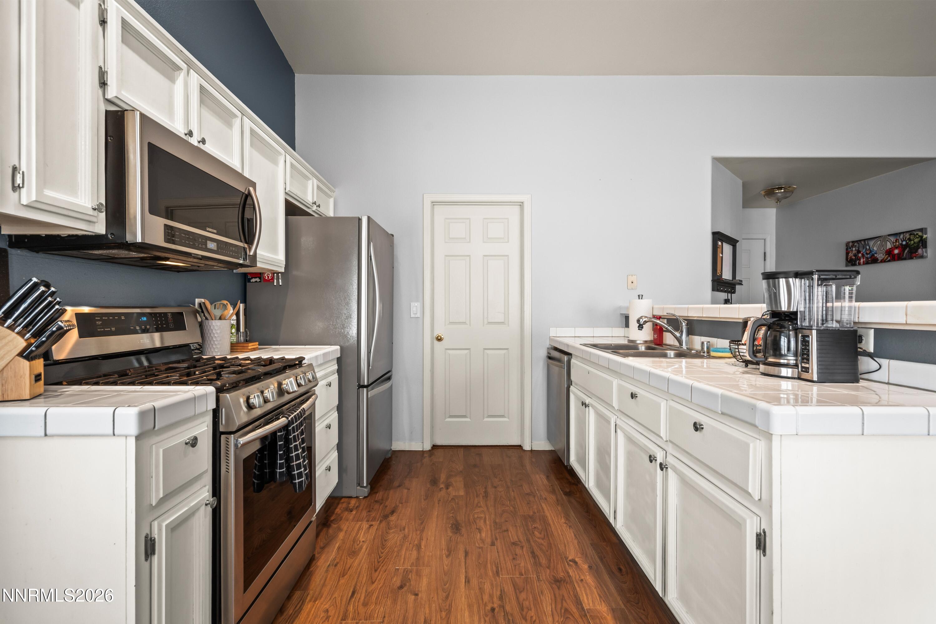 712 Hastings Way Fernley, NV 89408 - Photo 19 of 36 a kitchen with stainless steel appliances a stove microwave and cabinets