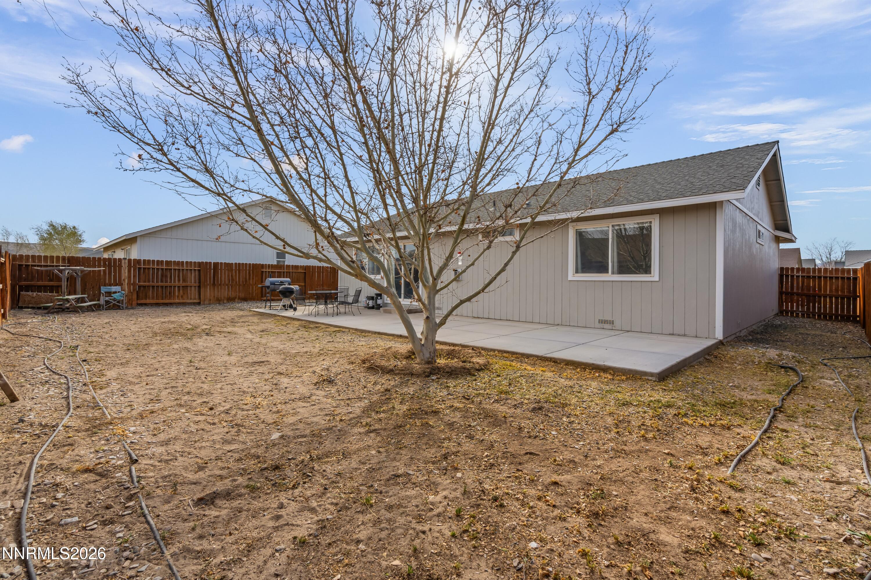 712 Hastings Way Fernley, NV 89408 - Photo 24 of 36 a house that has a tree in front of it