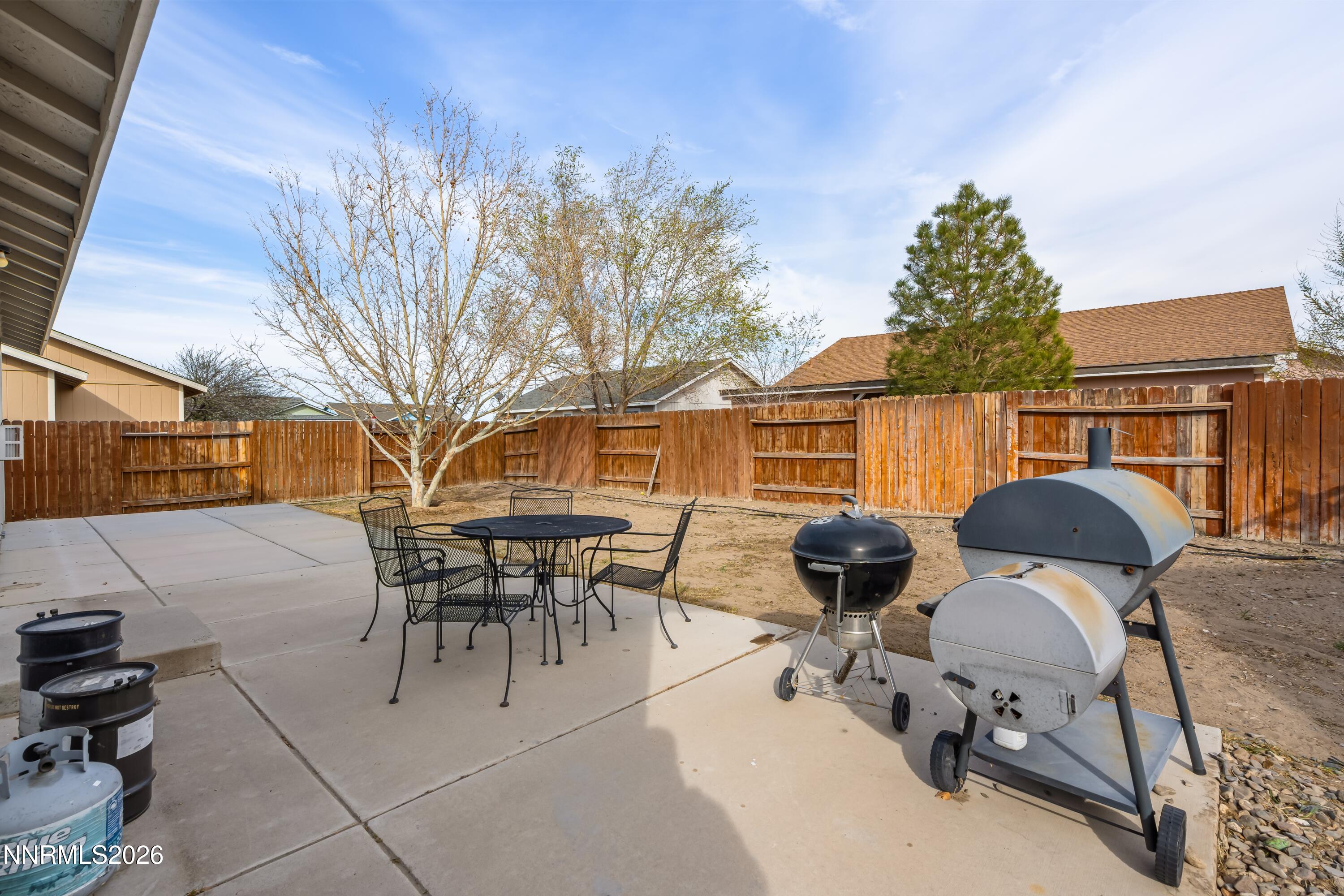 712 Hastings Way Fernley, NV 89408 - Photo 36 of 36 a view of a patio with table and chairs and potted plants