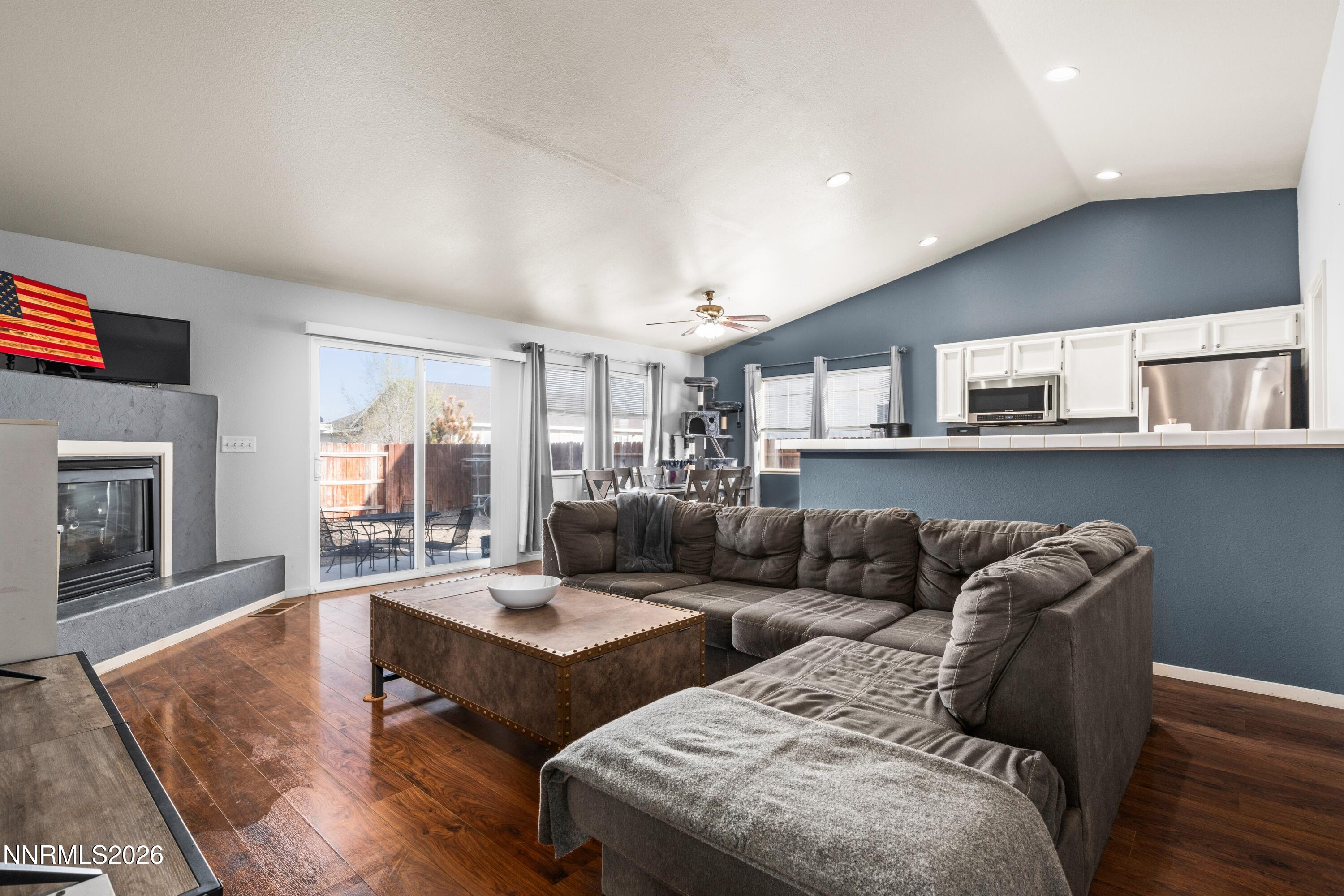 712 Hastings Way Fernley, NV 89408 - Photo 4 of 36 a living room with furniture wooden floor and a fireplace