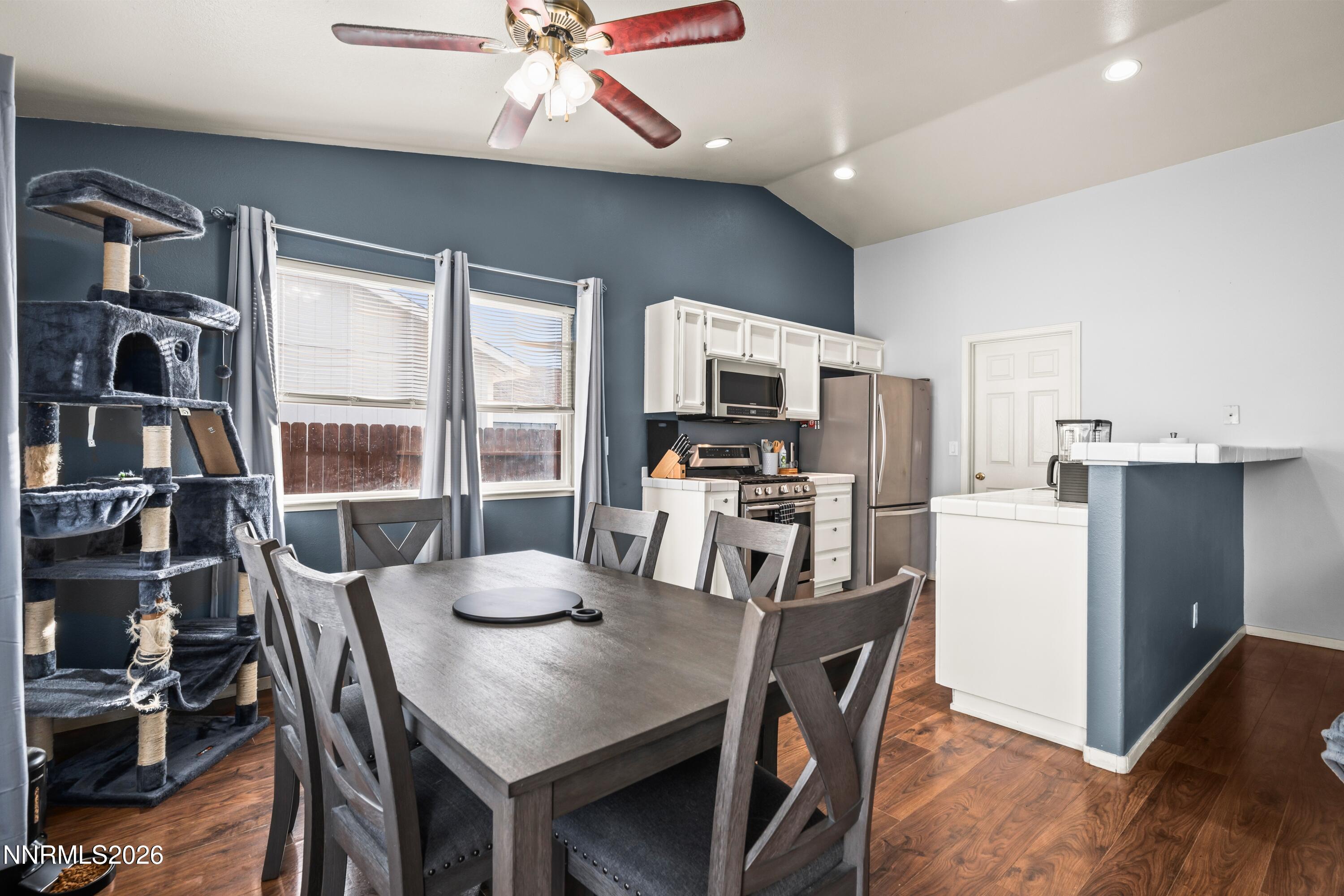 712 Hastings Way Fernley, NV 89408 - Photo 5 of 36 a kitchen with a table chairs refrigerator and microwave