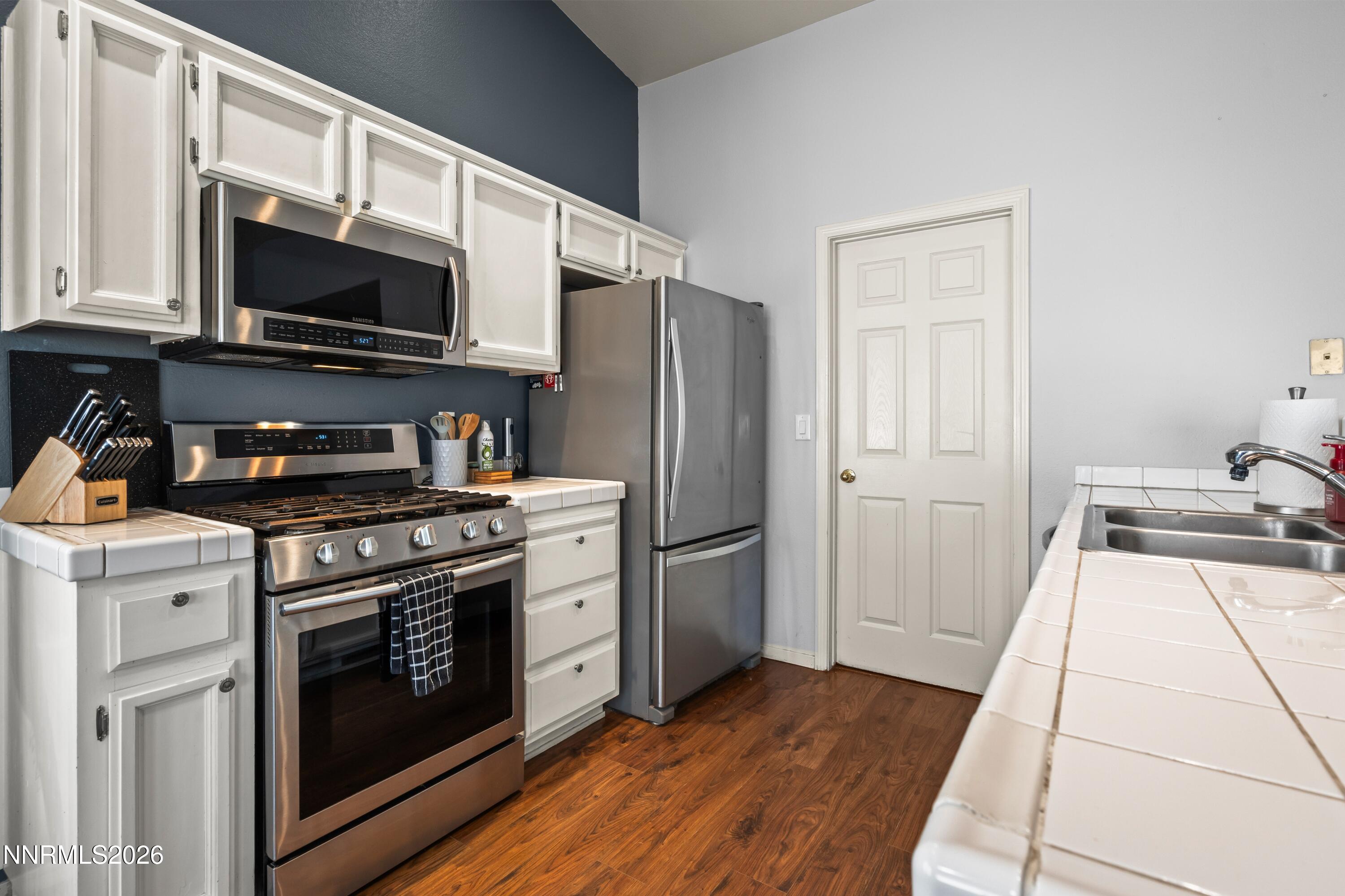 712 Hastings Way Fernley, NV 89408 - Photo 7 of 36 a kitchen with a stove a microwave and refrigerator