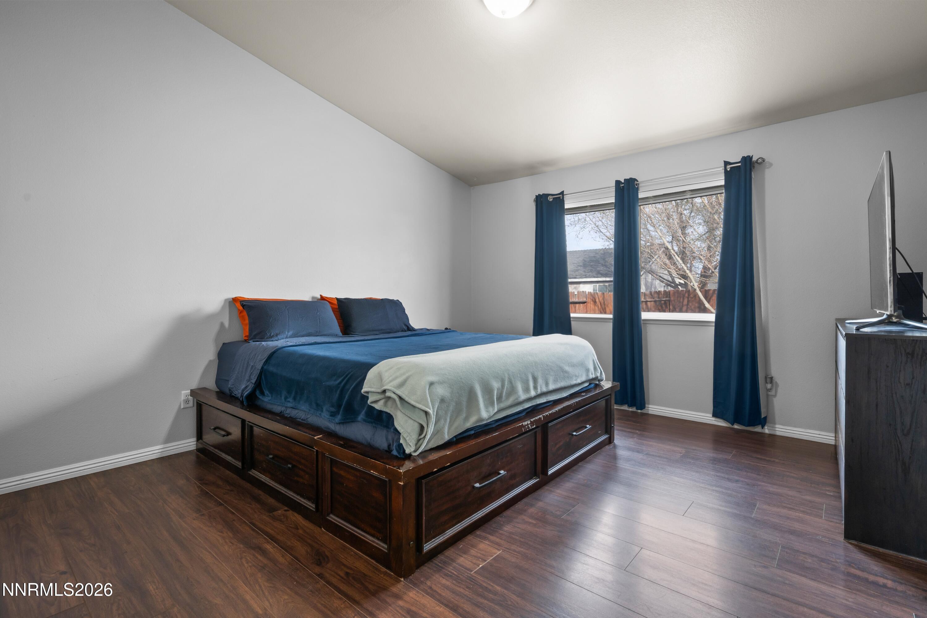712 Hastings Way Fernley, NV 89408 - Photo 9 of 36 a bedroom with a bed and wooden floor