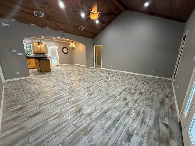 a kitchen with stainless steel appliances kitchen island granite countertop a refrigerator and a stove top oven