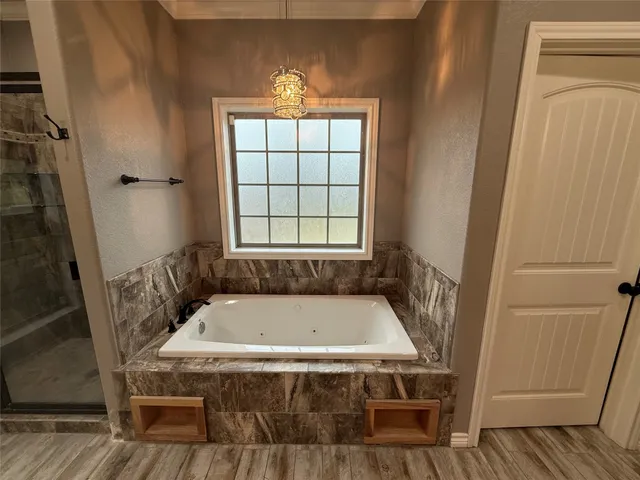 a kitchen with stainless steel appliances kitchen island granite countertop a refrigerator and a stove top oven