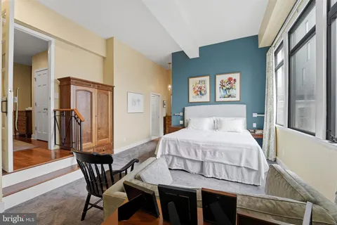 a bedroom with a bed and glass windows
