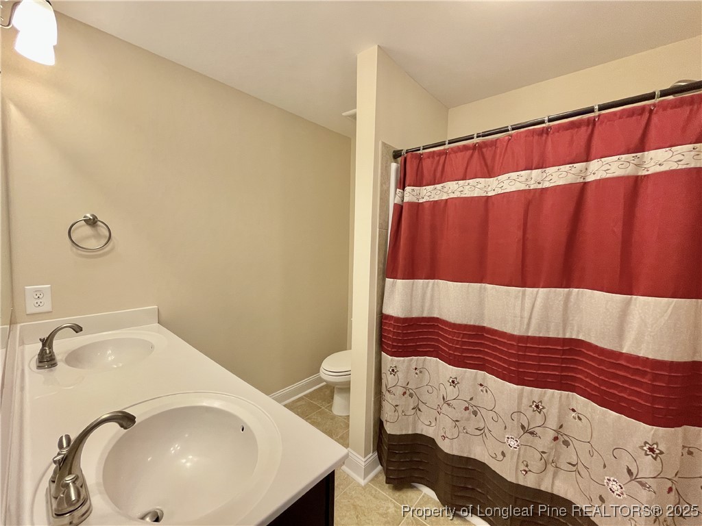 608 Stonebriar Avenue Raeford, NC 28376 - Photo 14 of 29 a bathroom with a sink and a mirror